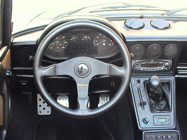 Sparco steering wheel. Sparco aluminum pedals (spaced farther apart)